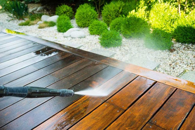 Region Painting cleaning terrace with a power washer - high water pressure clean